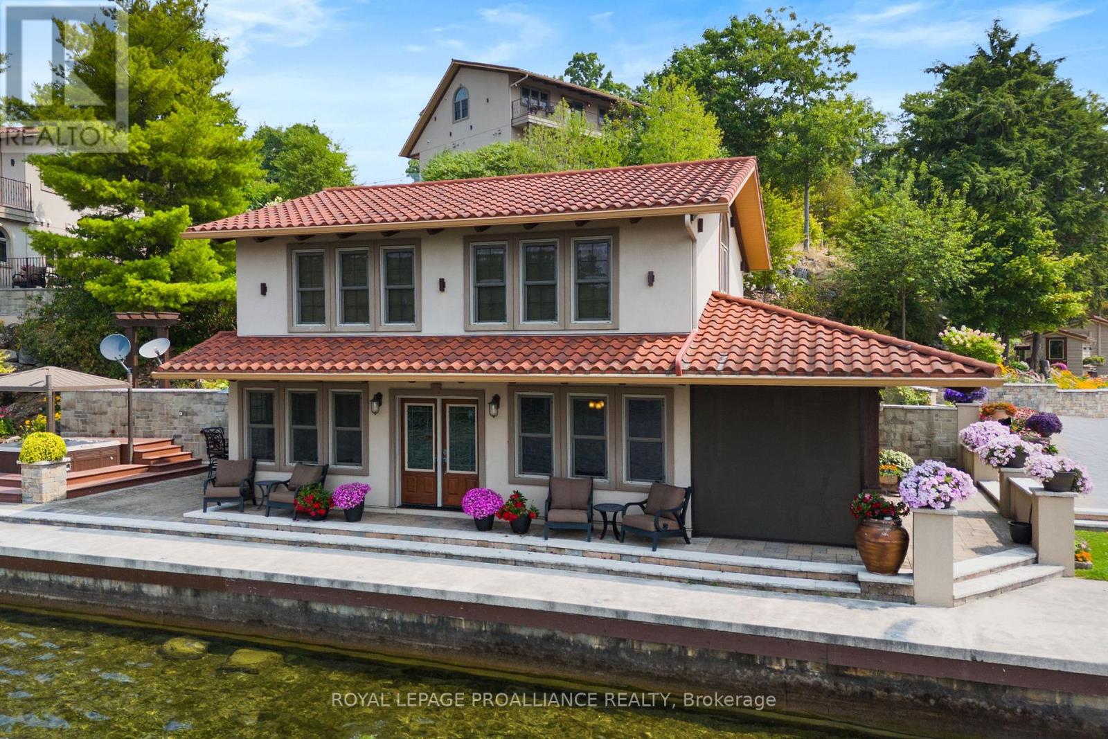 Two-storey boathouse with Italian tile roof and waterfront dock